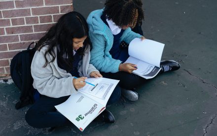 two teenage girls doing their homework together