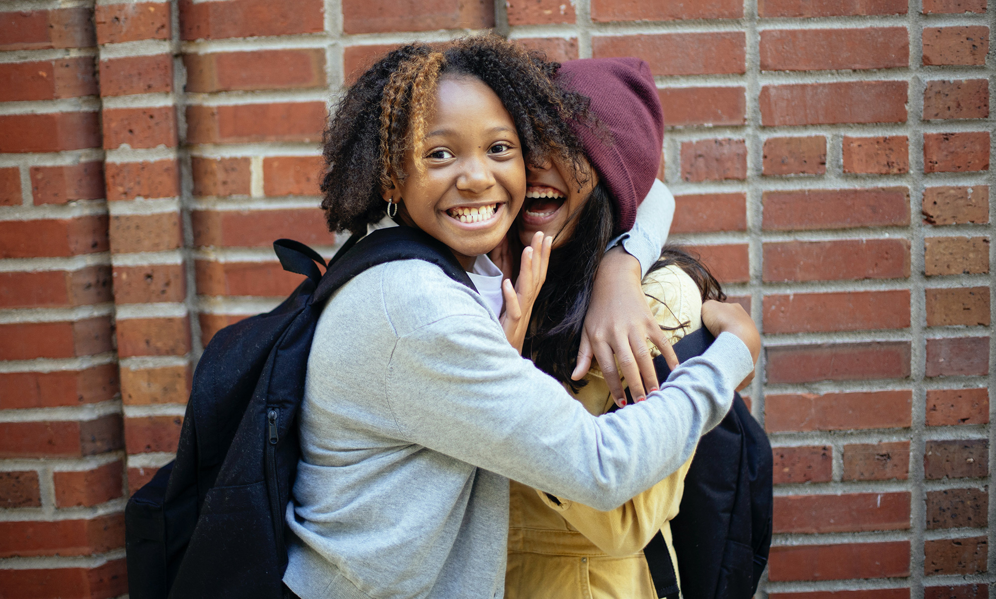 two teenagers hugging and smiling
